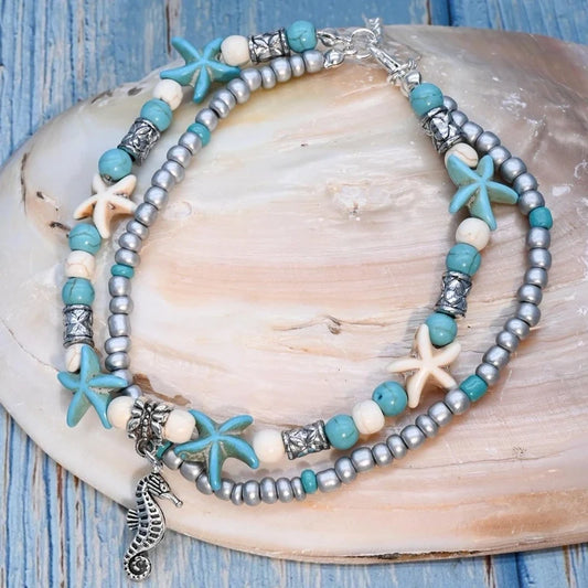 Βραχιόλι ποδιού με αστερίες & θαλάσσια charms σε γαλάζιο και ασημί – boho καλοκαιρινό στυλ