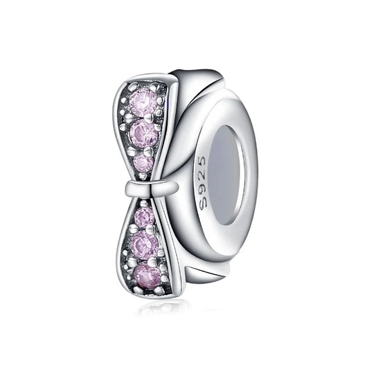 Ασημένιο charm σε σχήμα φιόγκου με ροζ πέτρες