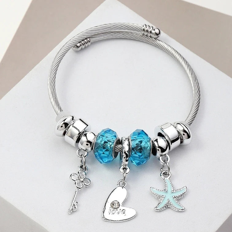 Ασημί βραχιόλι με μπλε charms και μοτίφ καρδιά & αστερία Ασημί βραχιόλι με μπλε charms και μοτίφ καρδιά & αστερία