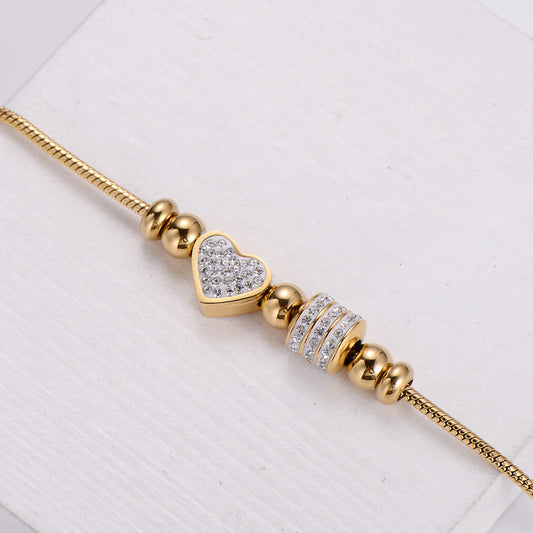 Επιχρυσωμένο βραχιόλι από ανοξείδωτο ατσάλι με charm καρδιά & ζιργκόν, βάρος 20g.