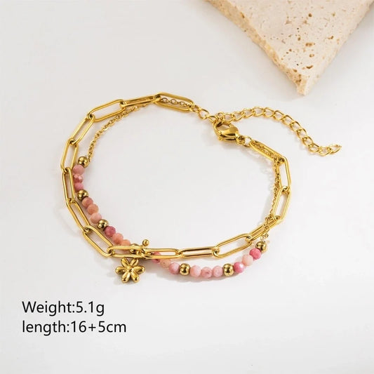 Επιχρυσωμένο 18K βραχιόλι με ροζ πετραδάκια και λουλουδένιο μοτίφ.