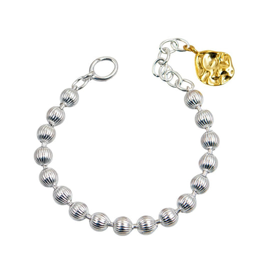 Ασημένιο βραχιόλι με ραβδωτές χάντρες και χρυσό στοιχείο στο κούμπωμα.