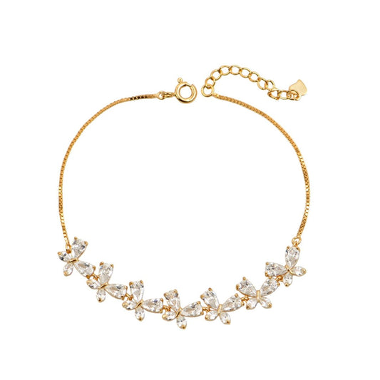 Χρυσό βραχιόλι με πεταλούδες και λαμπερά ζιργκόν σε μοντέρνο design.